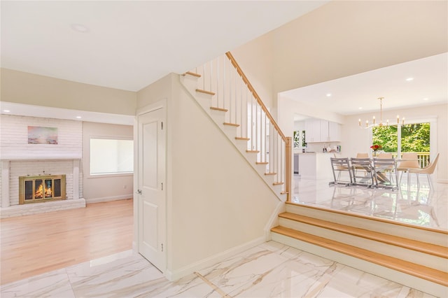 34 Winesap Ln, Monsey, NY 10952 - stairway with marble finish flooring, baseboards, a chandelier, a fireplace, and recessed lighting