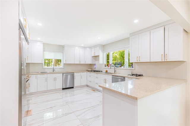 34 Winesap Ln, Monsey, NY 10952 - kitchen featuring stainless steel dishwasher, light marble finish flooring, a peninsula, light stone countertops, and recessed lighting