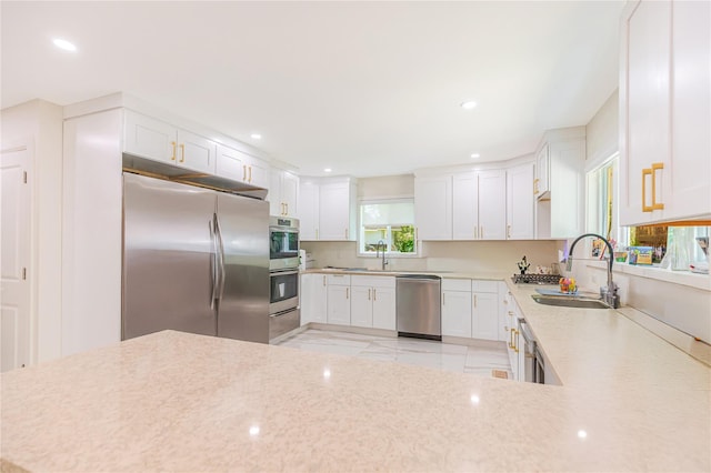 34 Winesap Ln, Monsey, NY 10952 - kitchen with appliances with stainless steel finishes, a sink, white cabinets, recessed lighting, and light stone countertops