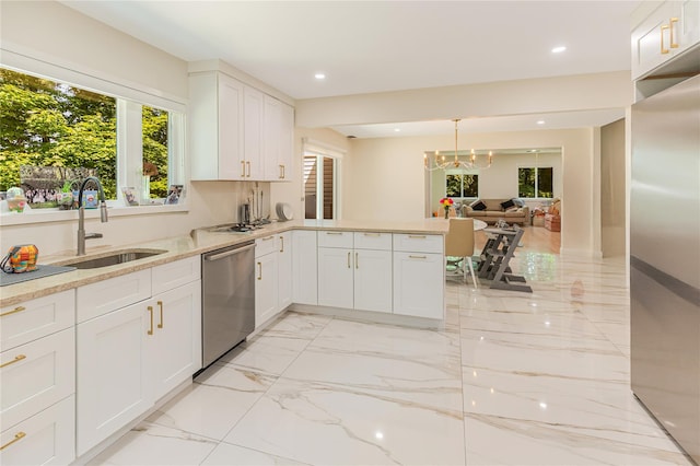 34 Winesap Ln, Monsey, NY 10952 - kitchen featuring appliances with stainless steel finishes, a sink, light marble finish floors, white cabinetry, and light stone counters