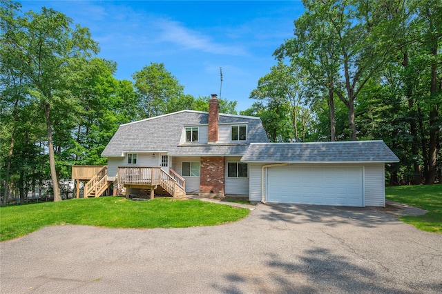 34 Winesap Ln, Monsey, NY 10952 - colonial inspired home featuring stairway, a gambrel roof, roof with shingles, an attached garage, and a front lawn