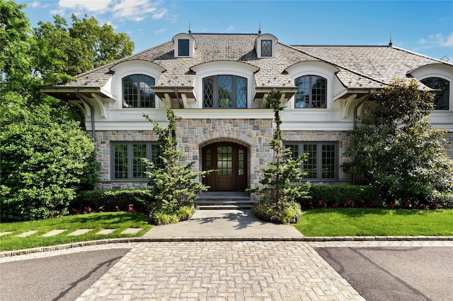 22 Terrace Ct, Old Westbury, NY 11568 - french country home with a high end roof, stone siding, french doors, and a front lawn