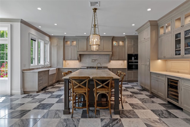 22 Terrace Ct, Old Westbury, NY 11568 - kitchen with beverage cooler, crown molding, recessed lighting, a kitchen island with sink, and backsplash