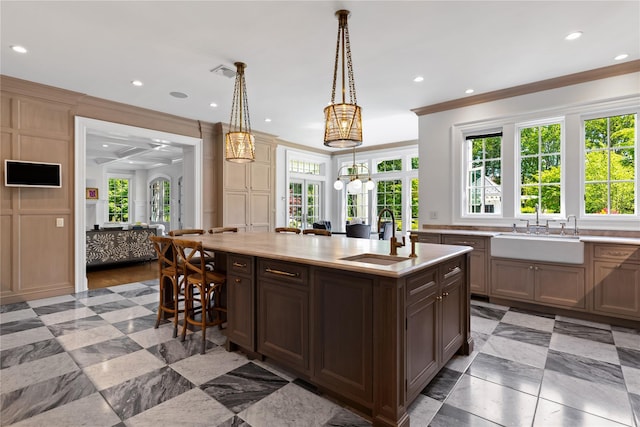 22 Terrace Ct, Old Westbury, NY 11568 - kitchen with light countertops, crown molding, a kitchen island with sink, plenty of natural light, and recessed lighting