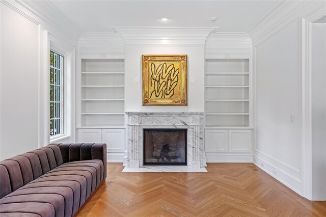 22 Terrace Ct, Old Westbury, NY 11568 - living room featuring built in shelves, ornamental molding, healthy amount of natural light, and a premium fireplace