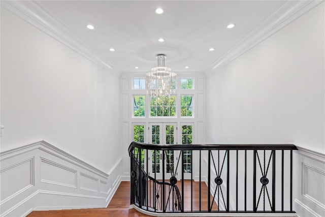 22 Terrace Ct, Old Westbury, NY 11568 - stairs with a chandelier, ornamental molding, a decorative wall, wood finished floors, and a wainscoted wall