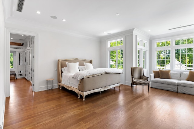 22 Terrace Ct, Old Westbury, NY 11568 - bedroom featuring ornamental molding, multiple windows, wood finished floors, and recessed lighting