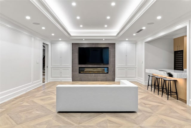 22 Terrace Ct, Old Westbury, NY 11568 - living room with wine cooler, a large fireplace, a raised ceiling, recessed lighting, and ornamental molding