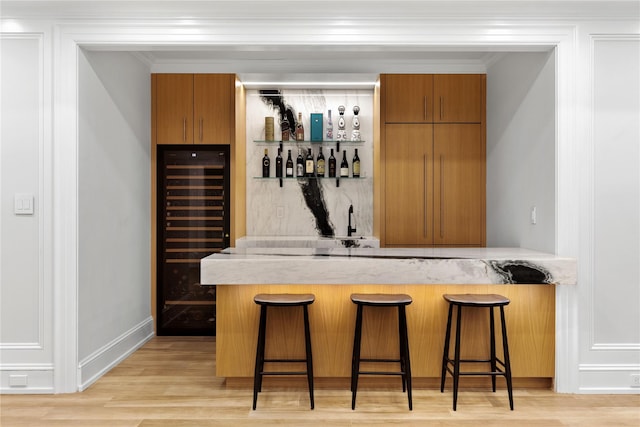 22 Terrace Ct, Old Westbury, NY 11568 - indoor wet bar featuring beverage cooler, ornamental molding, light wood-style floors, and decorative backsplash