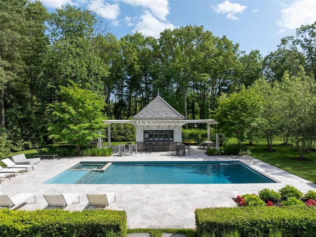 22 Terrace Ct, Old Westbury, NY 11568 - view of pool featuring a patio, an exterior structure, an outdoor structure, a pool with connected hot tub, and view of scattered trees