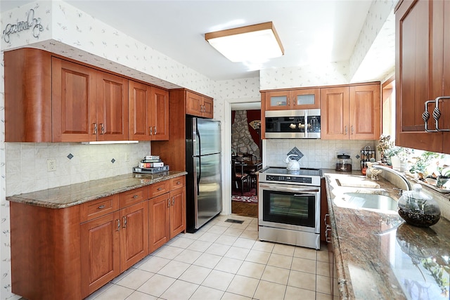 12 Rustic Gate Ln, Dix Hills, NY 11746 - kitchen featuring appliances with stainless steel finishes, wallpapered walls, a sink, backsplash, and light tile patterned floors