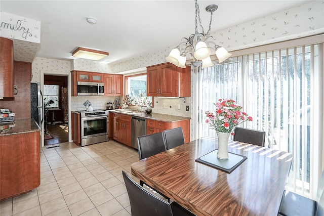 12 Rustic Gate Ln, Dix Hills, NY 11746 - dining room with a chandelier, wallpapered walls, and light tile patterned flooring