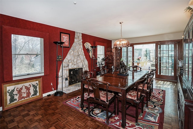 12 Rustic Gate Ln, Dix Hills, NY 11746 - dining area featuring a chandelier, a fireplace, and baseboards