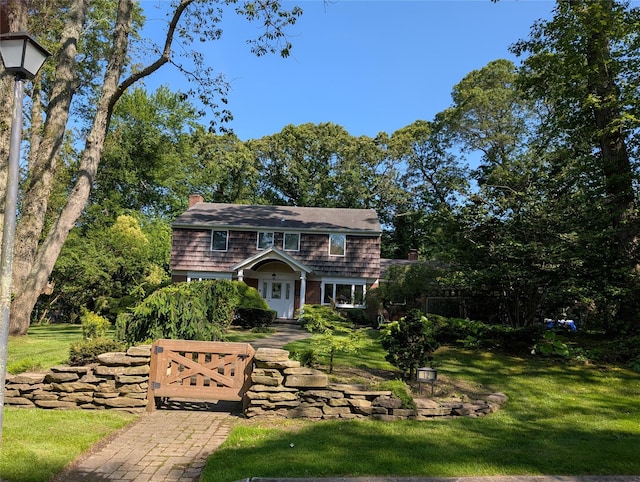12 Rustic Gate Ln, Dix Hills, NY 11746 - view of front of property featuring a chimney and a front yard