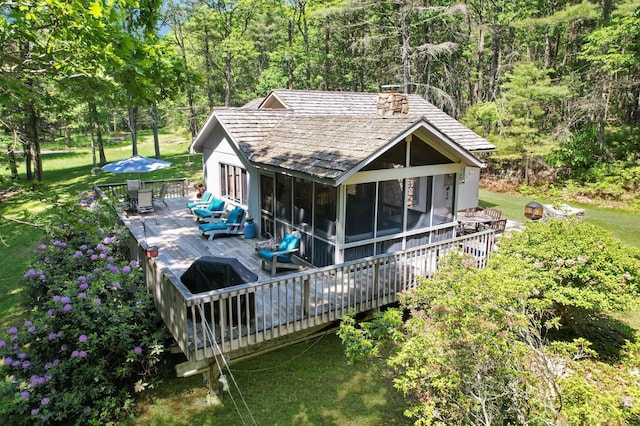141 Mountain Laurel Ln, Glen Spey, NY 12737 - back of house featuring a wooden deck, a sunroom, a lawn, and a forest view