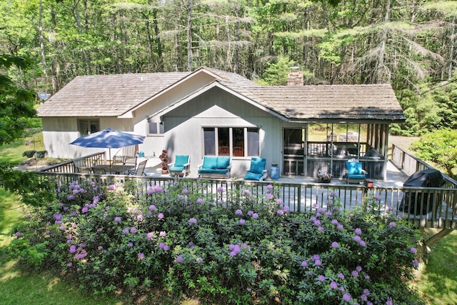 141 Mountain Laurel Ln, Glen Spey, NY 12737 - back of property featuring a chimney, a deck, and a forest view