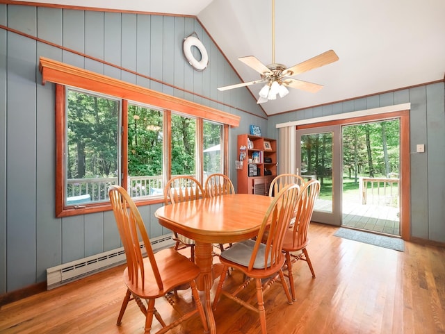 141 Mountain Laurel Ln, Glen Spey, NY 12737 - dining space featuring baseboard heating, lofted ceiling, wood finished floors, a ceiling fan, and a decorative wall
