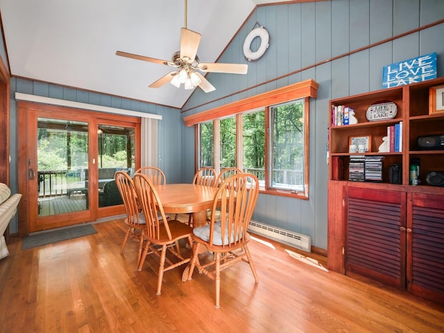 141 Mountain Laurel Ln, Glen Spey, NY 12737 - dining room featuring wood finished floors, vaulted ceiling, baseboard heating, and a ceiling fan