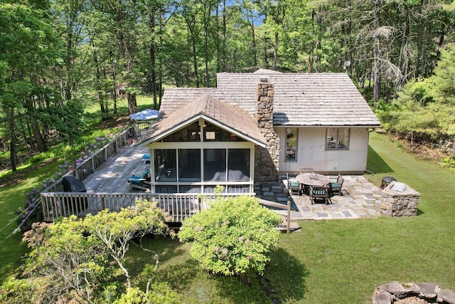 141 Mountain Laurel Ln, Glen Spey, NY 12737 - rear view of property featuring a lawn, a sunroom, a deck, and a patio area