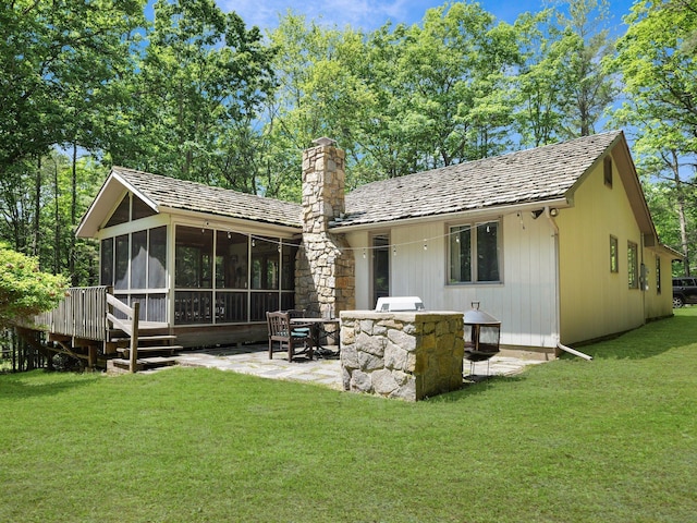141 Mountain Laurel Ln, Glen Spey, NY 12737 - back of property with a sunroom, a chimney, a yard, and a patio