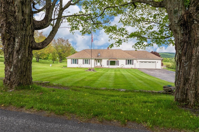 532 Wilbur Hill Rd, Unadilla, NY 13849 - view of front facade featuring an attached garage, asphalt driveway, and a front lawn