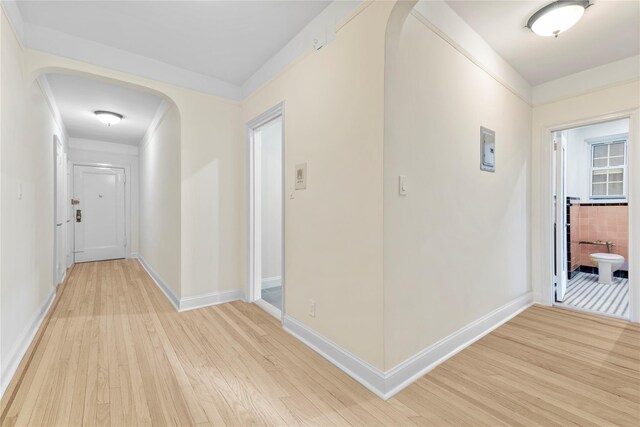 11007 73rd Rd Unit 4D, Forest Hills, NY 11375 - corridor with light wood-style floors, baseboards, and arched walkways