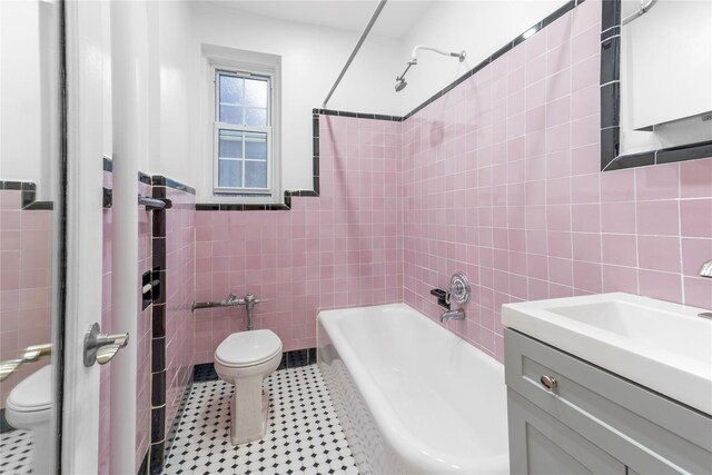 11007 73rd Rd Unit 4D, Forest Hills, NY 11375 - bathroom featuring toilet, tile walls, vanity, bathing tub / shower combination, and tile patterned floors