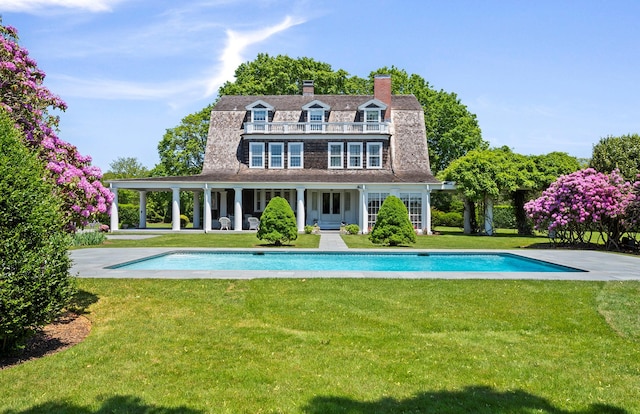 107 Quogue St, Quogue, NY 11959 - rear view of property featuring an outdoor pool, a gambrel roof, a lawn, a chimney, and a patio
