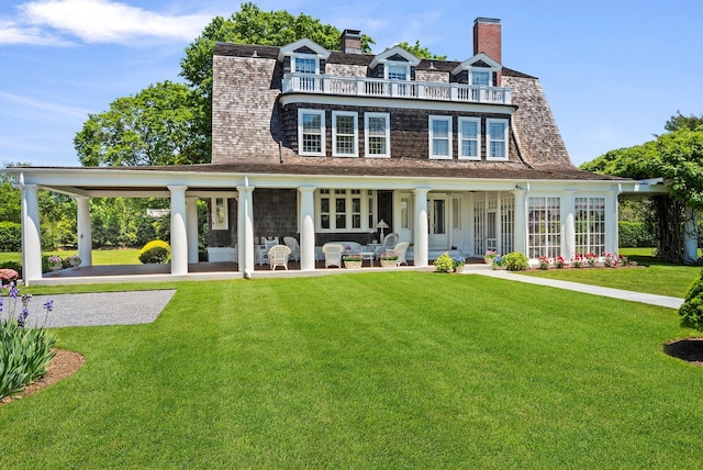 107 Quogue St, Quogue, NY 11959 - rear view of property with a lawn and a chimney