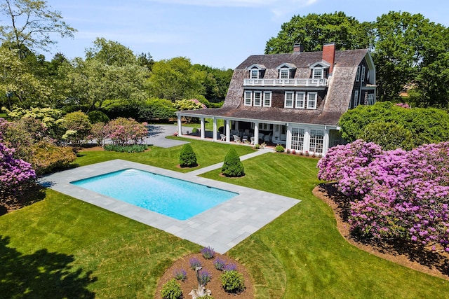 107 Quogue St, Quogue, NY 11959 - rear view of property featuring a gambrel roof, french doors, a patio area, a yard, and an outdoor pool