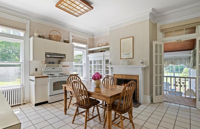 107 Quogue St, Quogue, NY 11959 - dining space with radiator, ornamental molding, light tile patterned flooring, plenty of natural light, and wallpapered walls