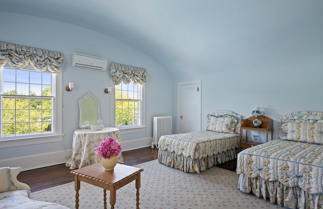 107 Quogue St, Quogue, NY 11959 - bedroom featuring radiator, a wall mounted AC, vaulted ceiling, and wood finished floors