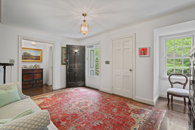 24 Wellington Rd, Locust Valley, NY 11560 - entryway featuring baseboards, crown molding, wood finished floors, and a chandelier