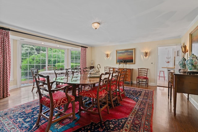 24 Wellington Rd, Locust Valley, NY 11560 - dining area with wood finished floors, healthy amount of natural light, ornamental molding, and baseboards