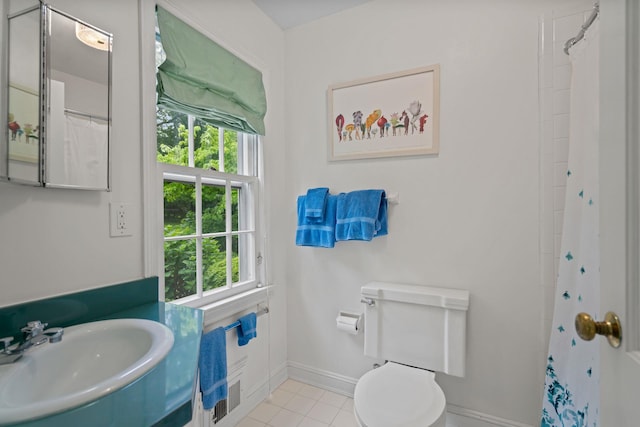 24 Wellington Rd, Locust Valley, NY 11560 - bathroom with plenty of natural light, a sink, baseboards, and toilet