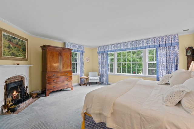 24 Wellington Rd, Locust Valley, NY 11560 - bedroom with light carpet, a warm lit fireplace, and ornamental molding
