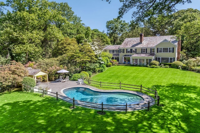 24 Wellington Rd, Locust Valley, NY 11560 - back of house featuring a gazebo, a chimney, an outdoor pool, and a patio