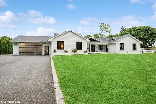 2650 Wickham Ave, Mattituck, NY 11952 - view of front of property featuring driveway, an attached garage, and a front yard
