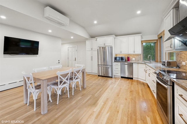 2650 Wickham Ave, Mattituck, NY 11952 - kitchen with appliances with stainless steel finishes, a wall unit AC, lofted ceiling, tasteful backsplash, and white cabinets