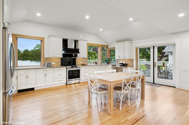 2650 Wickham Ave, Mattituck, NY 11952 - dining room featuring vaulted ceiling, recessed lighting, and light wood finished floors