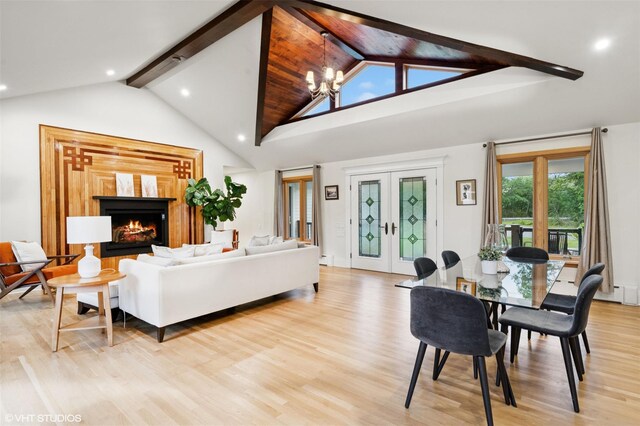 2650 Wickham Ave, Mattituck, NY 11952 - living area featuring light wood finished floors, a chandelier, recessed lighting, a warm lit fireplace, and french doors