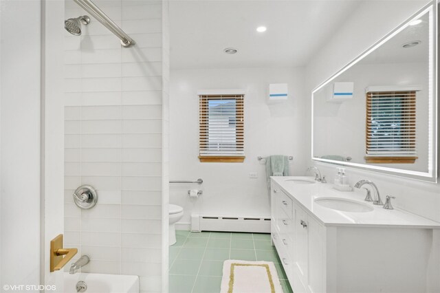 2650 Wickham Ave, Mattituck, NY 11952 - full bath with a baseboard radiator, double vanity, toilet, tile patterned floors, and shower / tub combination