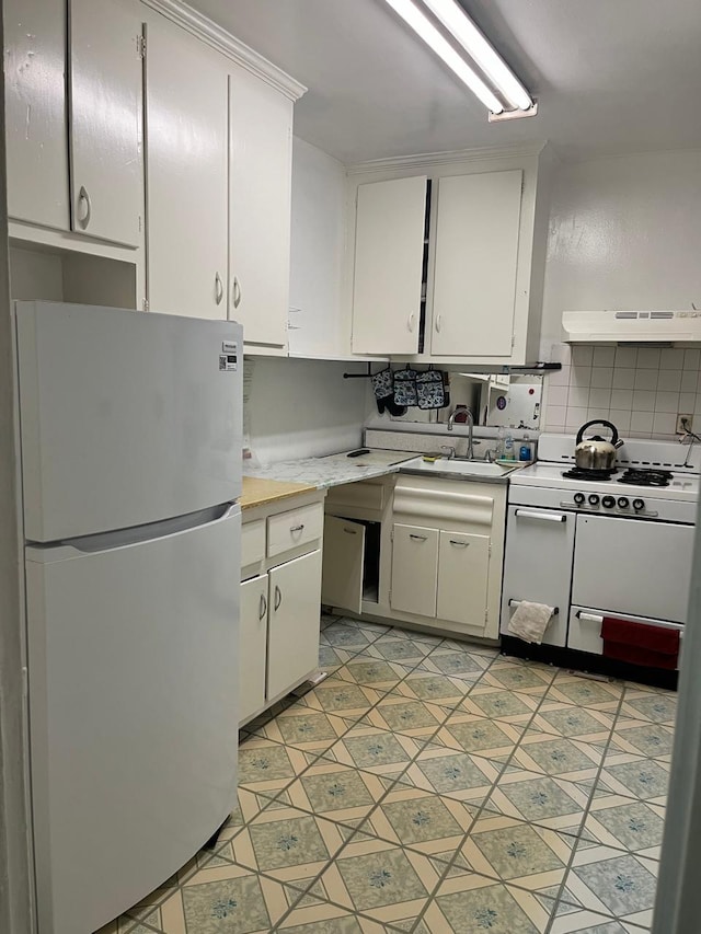 33-15 81st St Unit 2B, Jackson Heights, NY 11372 - kitchen featuring white appliances, light countertops, exhaust hood, white cabinetry, and a sink