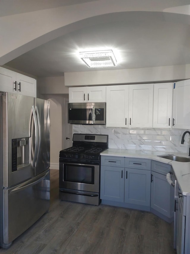 11 John Ave, Hempstead, NY 11003 - kitchen featuring appliances with stainless steel finishes, a sink, dark wood-style floors, and white cabinets