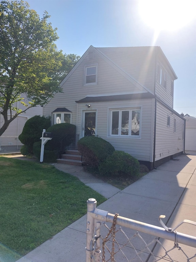 11 John Ave, Hempstead, NY 11003 - view of front of property featuring a front lawn