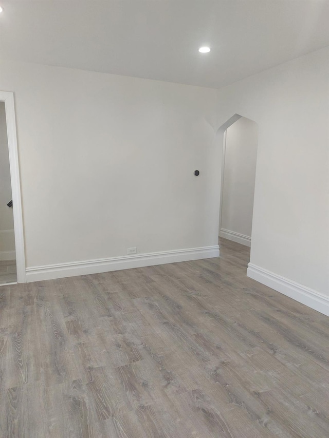 11 John Ave, Hempstead, NY 11003 - unfurnished room featuring arched walkways, recessed lighting, wood finished floors, and baseboards