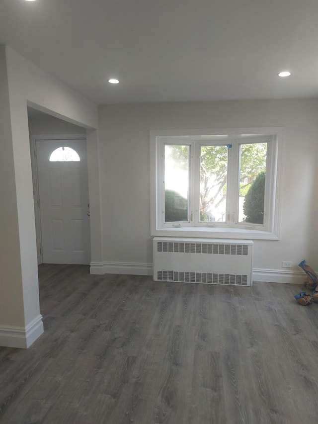 11 John Ave, Hempstead, NY 11003 - entrance foyer featuring radiator heating unit, baseboards, wood finished floors, and recessed lighting