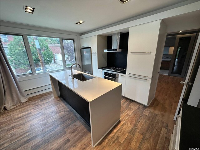 9-01 127th St, College Point, NY 11356 - kitchen featuring a sink, wall chimney exhaust hood, fridge, a baseboard radiator, and modern cabinets