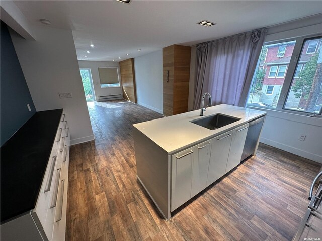 9-01 127th St, College Point, NY 11356 - kitchen featuring a sink, dark wood-style floors, a kitchen island with sink, baseboards, and recessed lighting