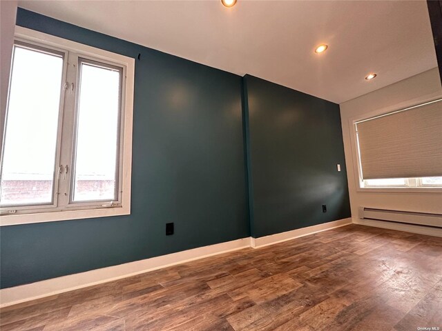 9-01 127th St, College Point, NY 11356 - unfurnished room featuring a baseboard radiator, wood finished floors, recessed lighting, and baseboards